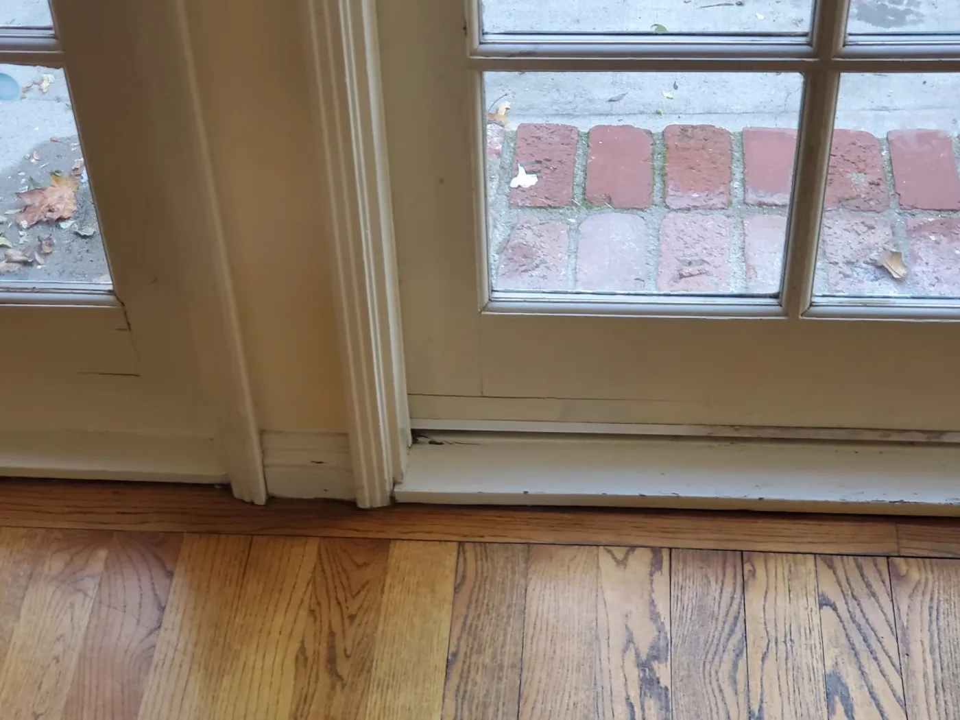 Before: Original hardwood floor worn dull and grey with age